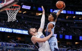 ORLANDO, FL - NOVEMBER 8: Ja Morant #12 of the Memphis Grizzlies attempts to dunk over Nikola Vucevic #9 of the Orlando Magic during the game at the Amway Center on November 8, 2019 in Orlando, Florida. The Magic defeated the Grizzlies 118 to 86. NOTE TO USER: User expressly acknowledges and agrees that, by downloading and or using this photograph, User is consenting to the terms and conditions of the Getty Images License Agreement. (Photo by Don Juan Moore/Getty Images)