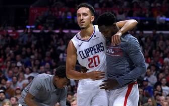 1187072456 LOS ANGELES, CALIFORNIA - NOVEMBER 11: Landry Shamet #20 of the LA Clippers is helped off the court by Patrick Beverley #21 during a 98-88 Clippers win over the Toronto Raptors at Staples Center on November 11, 2019 in Los Angeles, California. NOTE TO USER: User expressly acknowledges and agrees that, by downloading and/or using this photograph, user is consenting to the terms and conditions of the Getty Images License Agreement. (Photo by Harry How/Getty Images)