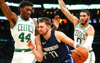 1181818324 BOSTON, MA - NOVEMBER 11: Luka Doncic #77 of the Dallas Mavericks dribbles the ball while guarded by Robert Williams III #44 of the Boston Celtics and Jayson Tatum #0 of the Boston Celtics during a game at TD Garden on November 11, 2019 in Boston, Massachusetts. NOTE TO USER: User expressly acknowledges and agrees that, by downloading and or using this photograph, User is consenting to the terms and conditions of the Getty Images License Agreement. (Photo by Adam Glanzman/Getty Images)