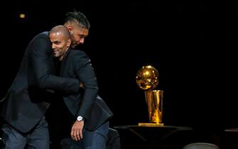 SAN ANTONIO,TX - NOVEMBER 11:  Tim Duncan hugs Tony Parker during his jersey retirement ceremony at AT&T Center on November 11, 2019 in San Antonio, Texas.  NOTE TO USER: User expressly acknowledges and agrees that , by downloading and or using this photograph, User is consenting to the terms and conditions of the Getty Images License Agreement. (Photo by Ronald Cortes/Getty Images)