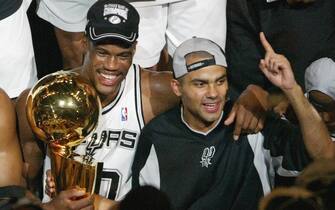 David Robinson (L) of the San Antonio Spurs and Frenchman Tony Parker celebrate after beating the New Jersey Nets in game six of the NBA Finals at SBC Center in San Antonio, Texas. The Spurs won the game 88-77 to win the best-of-seven game series 4-2.   AFP PHOTO/James NIELSEN  (Photo credit should read JAMES NIELSEN/AFP via Getty Images)