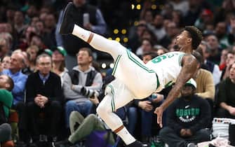 BOSTON, MASSACHUSETTS - JANUARY 23: Marcus Smart #36 of the Boston Celtics falls after a foul from Cedi Osman #16 of the Cleveland Cavaliers at TD Garden on January 23, 2019 in Boston, Massachusetts. NOTE TO USER: User expressly acknowledges and agrees that, by downloading and or using this photograph, User is consenting to the terms and conditions of the Getty Images License Agreement. (Photo by Maddie Meyer/Getty Images)