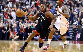 TORONTO, ON - DECEMBER 20:  Kyle Lowry #7 of the Toronto Raptors dribbles the ball as Bradley Beal #3 of the Washington Wizards defends during the second half of an NBA game at Scotiabank Arena on December 20, 2019 in Toronto, Canada.  NOTE TO USER: User expressly acknowledges and agrees that, by downloading and or using this photograph, User is consenting to the terms and conditions of the Getty Images License Agreement.  (Photo by Vaughn Ridley/Getty Images)