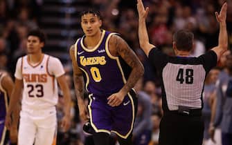 PHOENIX, ARIZONA - NOVEMBER 12: Kyle Kuzma #0 of the Los Angeles Lakers reacts after hitting a three point shot over Cameron Johnson #23 of the Phoenix Suns during the second half of the NBA game at Talking Stick Resort Arena on November 12, 2019 in Phoenix, Arizona. The Lakers defeated the Suns 123-115. NOTE TO USER: User expressly acknowledges and agrees that, by downloading and/or using this photograph, user is consenting to the terms and conditions of the Getty Images License Agreement  (Photo by Christian Petersen/Getty Images)
