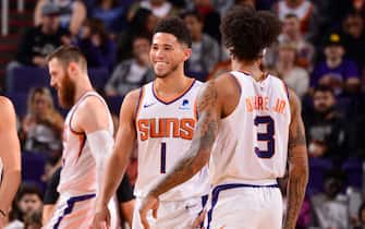 1182430753 PHOENIX, AZ - NOVEMBER 14: Devin Booker #1 of the Phoenix Suns smiles during a game against the Atlanta Hawks on November 14, 2019 at Talking Stick Resort Arena in Phoenix, Arizona. NOTE TO USER: User expressly acknowledges and agrees that, by downloading and or using this photograph, user is consenting to the terms and conditions of the Getty Images License Agreement. Mandatory Copyright Notice: Copyright 2019 NBAE (Photo by Barry Gossage/NBAE via Getty Images)