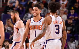 PHOENIX, AZ - NOVEMBER 14: Devin Booker #1 of the Phoenix Suns smiles during a game against the Atlanta Hawks on November 14, 2019 at Talking Stick Resort Arena in Phoenix, Arizona. NOTE TO USER: User expressly acknowledges and agrees that, by downloading and or using this photograph, user is consenting to the terms and conditions of the Getty Images License Agreement. Mandatory Copyright Notice: Copyright 2019 NBAE (Photo by Barry Gossage/NBAE via Getty Images)