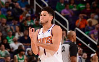 PHOENIX, AZ - NOVEMBER 18: Devin Booker #1 of the Phoenix Suns reacts to a play against the Boston Celtics on November 18, 2019 at Talking Stick Resort Arena in Phoenix, Arizona. NOTE TO USER: User expressly acknowledges and agrees that, by downloading and or using this photograph, user is consenting to the terms and conditions of the Getty Images License Agreement. Mandatory Copyright Notice: Copyright 2019 NBAE (Photo by Barry Gossage/NBAE via Getty Images)