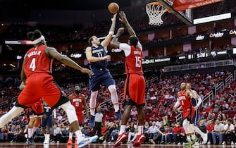 HOUSTON, TX - NOVEMBER 24:  Luka Doncic #77 of the Dallas Mavericks shoots the ball over Clint Capela #15 of the Houston Rockets in the second half at Toyota Center on November 24, 2019 in Houston, Texas.  NOTE TO USER: User expressly acknowledges and agrees that, by downloading and or using this photograph, User is consenting to the terms and conditions of the Getty Images License Agreement.  (Photo by Tim Warner/Getty Images)
