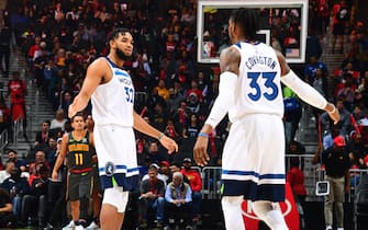 ATLANTA, GA - NOVEMBER 25: Karl-Anthony Towns #32 of the Minnesota Timberwolves and Robert Covington #33 of the Minnesota Timberwolves high-five during a game against the Atlanta Hawks on November 25, 2019 at State Farm Arena in Atlanta, Georgia.  NOTE TO USER: User expressly acknowledges and agrees that, by downloading and/or using this Photograph, user is consenting to the terms and conditions of the Getty Images License Agreement. Mandatory Copyright Notice: Copyright 2019 NBAE (Photo by Scott Cunningham/NBAE via Getty Images)