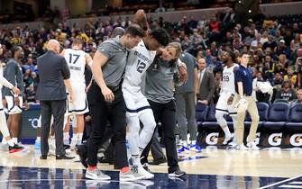 INDIANAPOLIS, INDIANA - NOVEMBER 25:  Ja Morant #12 of the Memphis Grizzlies is helped off of the court after being injured in the first half of the game  against the Indiana Pacers at Bankers Life Fieldhouse on November 25, 2019 in Indianapolis, Indiana.  NOTE TO USER: User expressly acknowledges and agrees that, by downloading and or using this photograph, User is consenting to the terms and conditions of the Getty Images License Agreement. (Photo by Andy Lyons/Getty Images)
