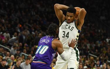 MILWAUKEE, WISCONSIN - NOVEMBER 25:  Giannis Antetokounmpo #34 of the Milwaukee Bucks is defended by Mike Conley #10 of the Utah Jazz during the second half of a game at Fiserv Forum on November 25, 2019 in Milwaukee, Wisconsin. NOTE TO USER: User expressly acknowledges and agrees that, by downloading and or using this photograph, User is consenting to the terms and conditions of the Getty Images License Agreement. (Photo by Stacy Revere/Getty Images)
