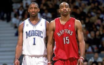 TORONTO - DECEMBER 21:  Tracy McGrady #1 of the Orlando Magic and Vince Carter #15 of the Toronto Raptors walk the court side by side during the NBA game at Air Canada Centre on December 21, 2003 in Toronto, Ontario, Canada.  The Magic won 104-93.  NOTE TO USER:  User expressly acknowledges and agrees that, by downloading and/or using this Photograph, User is consenting to the terms and conditions of the Getty Images License Agreement.  (Photo by Ron Turenne/NBAE via Getty Images) 