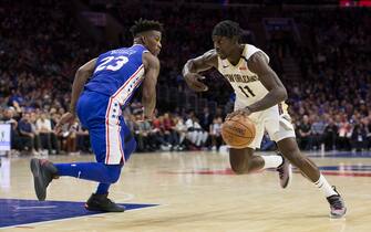 PHILADELPHIA, PA - NOVEMBER 21: Jrue Holiday #11 of the New Orleans Pelicans drives to the basket against Jimmy Butler #23 of the Philadelphia 76ers at the Wells Fargo Center on November 21, 2018 in Philadelphia, Pennsylvania. NOTE TO USER: User expressly acknowledges and agrees that, by downloading and or using this photograph, User is consenting to the terms and conditions of the Getty Images License Agreement. (Photo by Mitchell Leff/Getty Images)