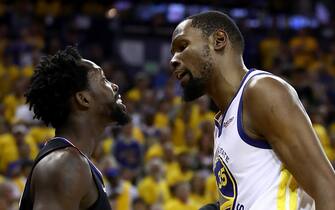 OAKLAND, CALIFORNIA - APRIL 13:   Kevin Durant #35 of the Golden State Warriors has words with Patrick Beverley #21 of the LA Clippers during Game One of the first round of the 2019 NBA Western Conference Playoffs at ORACLE Arena on April 13, 2019 in Oakland, California. Both players were ejected later in the game.  NOTE TO USER: User expressly acknowledges and agrees that, by downloading and or using this photograph, User is consenting to the terms and conditions of the Getty Images License Agreement. (Photo by Ezra Shaw/Getty Images)