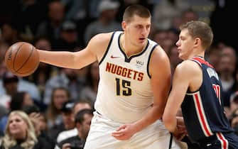 DENVER, COLORADO - NOVEMBER 26: Nikola Jokic #15 of the Denver Nuggets drives against Moritz Wagner #21 of the Washington Wizards in the first quarter at the Pepsi Center on November 26, 2019 in Denver, Colorado. NOTE TO USER: User expressly acknowledges and agrees that, by downloading and or using this photograph, User is consenting to the terms and conditions of the Getty Images License Agreement.  (Photo by Matthew Stockman/Getty Images)