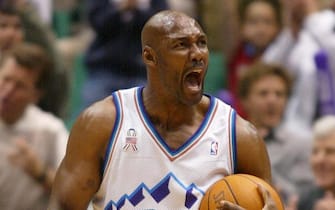 SALT LAKE CITY, UNITED STATES:  Karl Malone of the Utah Jazz roars to the crowd in a game against the Sacramento Kings during the first quarter of game 3, first round of the Western Conferance Play-offs, 27 April 2002 in Salt Lake City, Utah. AFP PHOTO/George FREY (Photo credit should read GEORGE FREY/AFP via Getty Images)