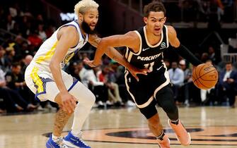 1191572492 ATLANTA, GEORGIA - DECEMBER 02: Trae Young #11 of the Atlanta Hawks drives against Ky Bowman #12 of the Golden State Warriors in the second half at State Farm Arena on December 02, 2019 in Atlanta, Georgia. NOTE TO USER: User expressly acknowledges and agrees that, by downloading and/or using this photograph, user is consenting to the terms and conditions of the Getty Images License Agreement. (Photo by Kevin C. Cox/Getty Images)