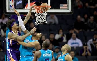 1191563685 CHARLOTTE, NORTH CAROLINA - DECEMBER 02: Kelly Oubre Jr. #3 of the Phoenix Suns dunks the ball over Miles Bridges #0 of the Charlotte Hornets during their game at Spectrum Center on December 02, 2019 in Charlotte, North Carolina. NOTE TO USER: User expressly acknowledges and agrees that, by downloading and or using this photograph, User is consenting to the terms and conditions of the Getty Images License Agreement. (Photo by Streeter Lecka/Getty Images)
