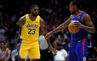 1184508527 LOS ANGELES, CALIFORNIA - OCTOBER 22: Kawhi Leonard #2 of the LA Clippers controls possession of the ball in front of LeBron James #23 of the Los Angeles Lakers late in the fourth quarter in a 112-102 Clipper win during the LA Clippers season home opener at Staples Center on October 22, 2019 in Los Angeles, California. (Photo by Harry How/Getty Images)
