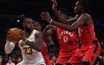 1186855602 LOS ANGELES, CALIFORNIA - NOVEMBER 10: LeBron James #23 of the Los Angeles Lakers is surrounded by Chris Boucher #25, Terence Davis #0 and Rondae Hollis-Jefferson #4 of the Toronto Raptors during a 113-104 Raptor win at Staples Center on November 10, 2019 in Los Angeles, California. NOTE TO USER: User expressly acknowledges and agrees that, by downloading and/or using this photograph, user is consenting to the terms and conditions of the Getty Images License Agreement. (Photo by Harry How/Getty Images)