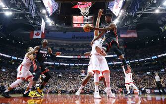 TORONTO, ON - DECEMBER 03:  Jimmy Butler #22 of the Miami Heat passes the ball as Marc Gasol #33 of the Toronto Raptors defends during the first half of an NBA game at Scotiabank Arena on December 03, 2019 in Toronto, Canada.  NOTE TO USER: User expressly acknowledges and agrees that, by downloading and or using this photograph, User is consenting to the terms and conditions of the Getty Images License Agreement.  (Photo by Vaughn Ridley/Getty Images)