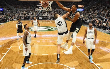 MILWAUKEE, WISCONSIN - DECEMBER 06:  Giannis Antetokounmpo #34 of the Milwaukee Bucks dunks over Ivica Zubac #40 of the Los Angeles Clippers during the second half of a game at Fiserv Forum on December 06, 2019 in Milwaukee, Wisconsin. NOTE TO USER: User expressly acknowledges and agrees that, by downloading and or using this photograph, User is consenting to the terms and conditions of the Getty Images License Agreement.  (Photo by Stacy Revere/Getty Images)