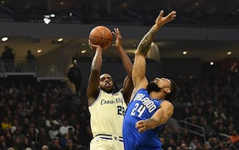 1192995352 MILWAUKEE, WISCONSIN - DECEMBER 09: Khris Middleton #22 of the Milwaukee Bucks shoots over Khem Birch #24 of the Orlando Magic during the first half of a game at Fiserv Forum on December 09, 2019 in Milwaukee, Wisconsin. NOTE TO USER: User expressly acknowledges and agrees that, by downloading and or using this photograph, User is consenting to the terms and conditions of the Getty Images License Agreement. (Photo by Stacy Revere/Getty Images)