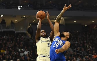 MILWAUKEE, WISCONSIN - DECEMBER 09:  Khris Middleton #22 of the Milwaukee Bucks shoots over Khem Birch #24 of the Orlando Magic during the first half of a game at Fiserv Forum on December 09, 2019 in Milwaukee, Wisconsin. NOTE TO USER: User expressly acknowledges and agrees that, by downloading and or using this photograph, User is consenting to the terms and conditions of the Getty Images License Agreement. (Photo by Stacy Revere/Getty Images)