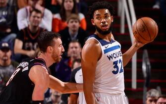 PHOENIX, AZ - DECEMBER 9: Karl-Anthony Towns #32 of the Minnesota Timberwolves handles the ball against the Phoenix Suns on December 9, 2019 at Talking Stick Resort Arena in Phoenix, Arizona. NOTE TO USER: User expressly acknowledges and agrees that, by downloading and or using this photograph, user is consenting to the terms and conditions of the Getty Images License Agreement. Mandatory Copyright Notice: Copyright 2019 NBAE (Photo by Barry Gossage/NBAE via Getty Images)