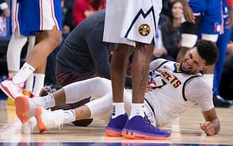 PHILADELPHIA, PA - DECEMBER 10: Jamal Murray #27 of the Denver Nuggets reacts after an injury in the first quarter against the Philadelphia 76ers at the Wells Fargo Center on December 10, 2019 in Philadelphia, Pennsylvania. NOTE TO USER: User expressly acknowledges and agrees that, by downloading and/or using this photograph, user is consenting to the terms and conditions of the Getty Images License Agreement. (Photo by Mitchell Leff/Getty Images)