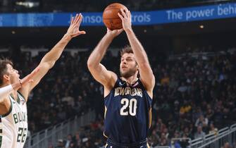 1188066575 MILWAUKEE, WI - DECEMBER 11: Nicolo Melli #20 of the New Orleans Pelicans shoots three point basket against the Milwaukee Bucks on December 11, 2019 at the Fiserv Forum Center in Milwaukee, Wisconsin. NOTE TO USER: User expressly acknowledges and agrees that, by downloading and or using this Photograph, user is consenting to the terms and conditions of the Getty Images License Agreement. Mandatory Copyright Notice: Copyright 2019 NBAE (Photo by Gary Dineen/NBAE via Getty Images).