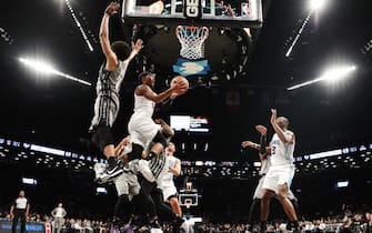 1193425143 NEW YORK, NEW YORK - DECEMBER 11: Devonte' Graham #4 of the Charlotte Hornets takes a shot past Jarrett Allen #31 of the Brooklyn Nets during the second half of their game at Barclays Center on December 11, 2019 in New York City. NOTE TO USER: User expressly acknowledges and agrees that, by downloading and or using this photograph, User is consenting to the terms and conditions of the Getty Images License Agreement. (Photo by Emilee Chinn/Getty Images)