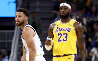 SAN FRANCISCO, CALIFORNIA - OCTOBER 05:  LeBron James #23 of the Los Angeles Lakers talks to Stephen Curry #30 of the Golden State Warriors during their game at Chase Center on October 05, 2019 in San Francisco, California.  NOTE TO USER: User expressly acknowledges and agrees that, by downloading and or using this photograph, User is consenting to the terms and conditions of the Getty Images License Agreement.  (Photo by Ezra Shaw/Getty Images)