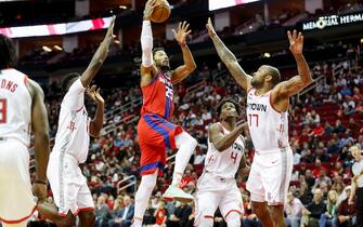 HOUSTON, TX - DECEMBER 14:  Derrick Rose #25 of the Detroit Pistons goes up for a shot defended by PJ Tucker #17 of the Houston Rockets and Clint Capela #15 in the second half at Toyota Center on December 14, 2019 in Houston, Texas.  NOTE TO USER: User expressly acknowledges and agrees that, by downloading and or using this photograph, User is consenting to the terms and conditions of the Getty Images License Agreement.  (Photo by Tim Warner/Getty Images)