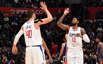 LOS ANGELES, CA - DECEMBER 17: Ivica Zubac #40 of the LA Clippers high fives teammate, Paul George #13 during the game against the Phoenix Suns on December 17, 2019 at STAPLES Center in Los Angeles, California. NOTE TO USER: User expressly acknowledges and agrees that, by downloading and/or using this Photograph, user is consenting to the terms and conditions of the Getty Images License Agreement. Mandatory Copyright Notice: Copyright 2019 NBAE (Photo by Andrew D. Bernstein/NBAE via Getty Images)