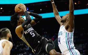 CHARLOTTE, NORTH CAROLINA - DECEMBER 17: De'Aaron Fox #5 of the Sacramento Kings tries to take a shot over Michael Kidd-Gilchrist #14 of the Charlotte Hornets during the second quarter during their game at the Spectrum Center on December 17, 2019 in Charlotte, North Carolina. NOTE TO USER: User expressly acknowledges and agrees that, by downloading and/or using this photograph, user is consenting to the terms and conditions of the Getty Images License Agreement. (Photo by Jacob Kupferman/Getty Images)