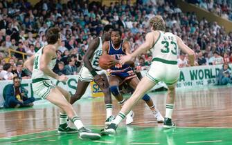 BOSTON - 1984:  Darrell Walker #4 of the New York Knicks drives to the basket against Danny Ainge #44 and Larry Bird #33 of the Boston Celtics during a game played in 1984 at the Boston Garden in Boston, Massachusetts. NOTE TO USER: User expressly acknowledges and agrees that, by downloading and or using this photograph, User is consenting to the terms and conditions of the Getty Images License Agreement. Mandatory Copyright Notice: Copyright 1984 NBAE (Photo by Dick Raphael/NBAE via Getty Images)