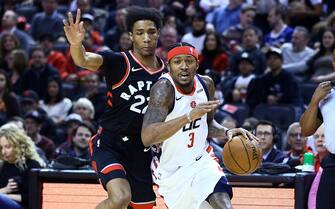 TORONTO, ON - DECEMBER 20:  Bradley Beal #3 of the Washington Wizards dribbles the ball as Patrick McCaw #22 of the Toronto Raptors defends during the first half of an NBA game at Scotiabank Arena on December 20, 2019 in Toronto, Canada.  NOTE TO USER: User expressly acknowledges and agrees that, by downloading and or using this photograph, User is consenting to the terms and conditions of the Getty Images License Agreement.  (Photo by Vaughn Ridley/Getty Images)