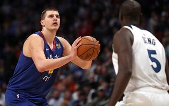 DENVER, COLORADO - DECEMBER 20: Nikola Jokic #15 of the Denver Nuggets puts up a shot against Gorgui Dieng #5 of the Minnesota Timberwolves in the fourth quarter at the Pepsi Center on December 20, 2019 in Denver, Colorado. NOTE TO USER: User expressly acknowledges and agrees that, by downloading and or using this photograph, User is consenting to the terms and conditions of the Getty Images License Agreement. (Photo by Matthew Stockman/Getty Images)