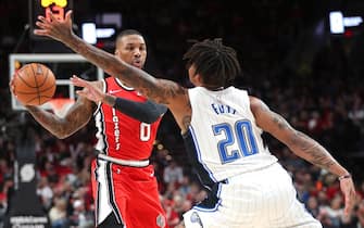 PORTLAND, OREGON - DECEMBER 20: Damian Lillard #0 of the Portland Trail Blazers works against Markelle Fultz #20 of the Orlando Magic in the first quarter during their game at Moda Center on December 20, 2019 in Portland, Oregon. NOTE TO USER: User expressly acknowledges and agrees that, by downloading and or using this photograph, User is consenting to the terms and conditions of the Getty Images License Agreement (Photo by Abbie Parr/Getty Images)