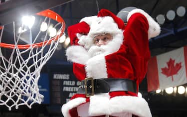 SACRAMENTO, CA - DECEMBER 10: A man dressed as Santa Claus dunks during the game between the New York Knicks and Sacramento Kings on December 10, 2015 at Sleep Train Arena in Sacramento, California. NOTE TO USER: User expressly acknowledges and agrees that, by downloading and or using this photograph, User is consenting to the terms and conditions of the Getty Images Agreement. Mandatory Copyright Notice: Copyright 2015 NBAE (Photo by Rocky Widner/NBAE via Getty Images)