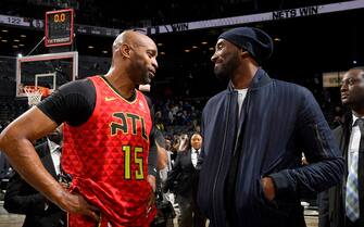 BROOKLYN, NY - DECEMBER 21: Vince Carter #15 of the Atlanta Hawks talks with Former NBA Player, Kobe Bryant after the game against the Brooklyn Nets on December 21, 2019 at Barclays Center in Brooklyn, New York. NOTE TO USER: User expressly acknowledges and agrees that, by downloading and or using this photograph, User is consenting to the terms and conditions of the Getty Images License Agreement. Mandatory Copyright Notice: Copyright 2019 NBAE  (Photo by Brian Babineau/NBAE via Getty Images)