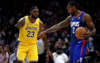 LOS ANGELES, CALIFORNIA - OCTOBER 22:   Kawhi Leonard #2 of the LA Clippers controls possession of the ball in front of LeBron James #23 of the Los Angeles Lakers late in the fourth quarter in a 112-102 Clipper win during the LA Clippers season home opener at Staples Center on October 22, 2019 in Los Angeles, California. (Photo by Harry How/Getty Images)
