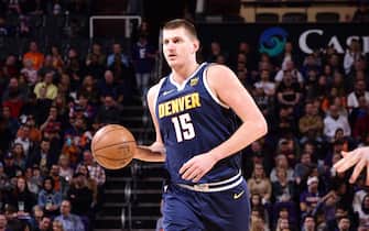 PHOENIX, AZ - DECEMBER 23: Nikola Jokic #15 of the Denver Nuggets handles the ball during the game against the Phoenix Suns on December 23, 2019 at Talking Stick Resort Arena in Phoenix, Arizona. NOTE TO USER: User expressly acknowledges and agrees that, by downloading and or using this photograph, user is consenting to the terms and conditions of the Getty Images License Agreement. Mandatory Copyright Notice: Copyright 2019 NBAE (Photo by Michael Gonzales/NBAE via Getty Images)