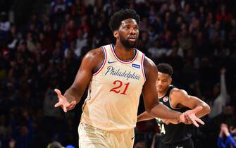 PHILADELPHIA, PA - DECEMBER 25: Joel Embiid #21 of the Philadelphia 76ers reacts to a play against the Milwaukee Bucks on December 25, 2019 at the Wells Fargo Center in Philadelphia, Pennsylvania. NOTE TO USER: User expressly acknowledges and agrees that, by downloading and/or using this Photograph, user is consenting to the terms and conditions of the Getty Images License Agreement. Mandatory Copyright Notice: Copyright 2019 NBAE (Photo by Jesse D. Garrabrant/NBAE via Getty Images)
