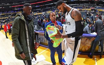 LOS ANGELES, CA - DECEMBER 25: Paul George #13 of the LA Clippers signs and gives his sneakers away to a fan after the game against the Los Angeles Lakers on December 25, 2019 at STAPLES Center in Los Angeles, California. NOTE TO USER: User expressly acknowledges and agrees that, by downloading and/or using this Photograph, user is consenting to the terms and conditions of the Getty Images License Agreement. Mandatory Copyright Notice: Copyright 2019 NBAE (Photo by Andrew D. Bernstein/NBAE via Getty Images)