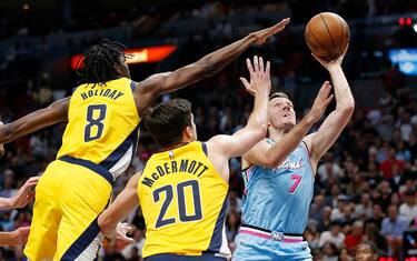 MIAMI, FLORIDA - DECEMBER 27: Goran Dragic #7 of the Miami Heat shoots against Doug McDermott #20 and Justin Holiday #8 of the Indiana Pacers during the second half at American Airlines Arena on December 27, 2019 in Miami, Florida. NOTE TO USER: User expressly acknowledges and agrees that, by downloading and/or using this photograph, user is consenting to the terms and conditions of the Getty Images License Agreement.  (Photo by Michael Reaves/Getty Images)