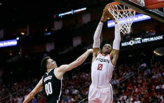 HOUSTON, TEXAS - DECEMBER 28: Russell Westbrook #0 of the Houston Rockets dunks over Rodions Kurucs #00 of the Brooklyn Nets during the fourth quarter at Toyota Center on December 28, 2019 in Houston, Texas. NOTE TO USER: User expressly acknowledges and agrees that, by downloading and/or using this photograph, user is consenting to the terms and conditions of the Getty Images License Agreement.  (Photo by Bob Levey/Getty Images)
