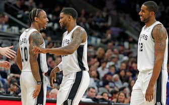 SAN ANTONIO, TX - DECEMBER 28:  DeMar DeRozan #10 of the San Antonio Spurs celebrates with Rudy Gay #22 and LaMarcus Aldridge #12 during a time-out in game against the Detroit Pistons during second half action at AT&T Center on December 28, 2019 in San Antonio, Texas.  San Antonio Spurs defeated the Detroit Pistons 136-109.  NOTE TO USER: User expressly acknowledges and agrees that , by downloading and or using this photograph, User is consenting to the terms and conditions of the Getty Images License Agreement. (Photo by Ronald Cortes/Getty Images)