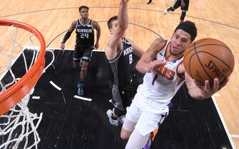 SACRAMENTO, CA - DECEMBER 28: Devin Booker #1 of the Phoenix Suns drives to the basket during the game against the Sacramento Kings on December 28, 2019 at Golden 1 Center in Sacramento, California. NOTE TO USER: User expressly acknowledges and agrees that, by downloading and or using this Photograph, user is consenting to the terms and conditions of the Getty Images License Agreement. Mandatory Copyright Notice: Copyright 2019 NBAE (Photo by Rocky Widner/NBAE via Getty Images)